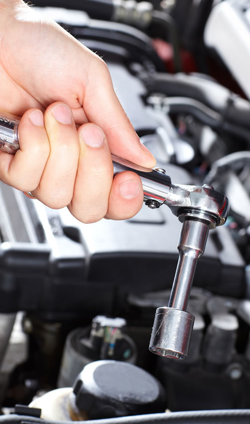 A person holding a wrench in their hand.